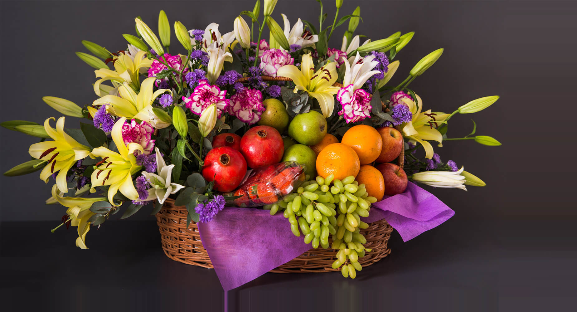 Premium fruits and cakes gifting hamper with flowers