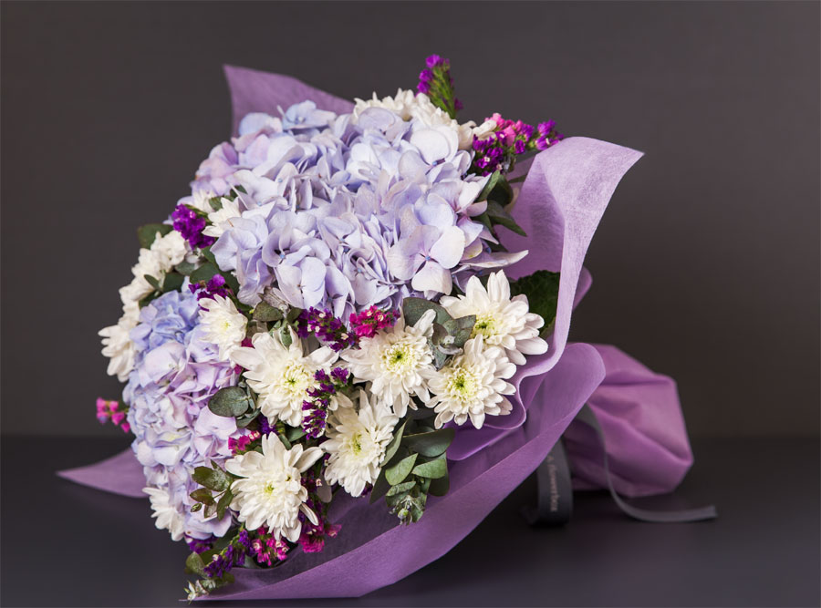 Elegant premium bouquet featuring blue flower hydrangeas arranged by Flowerbox